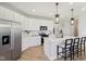 Bright kitchen featuring white cabinets, stainless steel appliances, and a large island with bar seating at 2693 Penn Ave, Plainfield, IN 46168