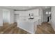 Open kitchen with an island, white cabinets, and stainless steel appliances at 2693 Penn Ave, Plainfield, IN 46168