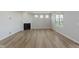 Spacious living room with wood floors, a fireplace, and plenty of natural light at 2693 Penn Ave, Plainfield, IN 46168