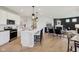 Open floor plan with kitchen island open to living room and fireplace at 2693 Penn Ave, Plainfield, IN 46168