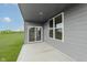 Rear patio of the house with sliding glass door offers relaxing view of lawn at 2693 Penn Ave, Plainfield, IN 46168