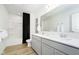 Bright bathroom featuring a double vanity, large mirror, and a shower-tub combo, providing a functional and stylish space at 2705 Penn Ave, Plainfield, IN 46168