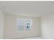 Cozy bedroom has a large window with a lovely exterior view and soft neutral carpeting at 2705 Penn Ave, Plainfield, IN 46168