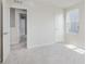 Bright bedroom features neutral carpet and paint with a view into an ensuite bathroom at 2705 Penn Ave, Plainfield, IN 46168
