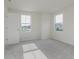 Well-lit bedroom featuring neutral walls and carpet with view of neighborhood through the windows at 2705 Penn Ave, Plainfield, IN 46168