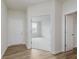 Bright entryway featuring wood floors, white trim and doors, and a view to the front room at 2705 Penn Ave, Plainfield, IN 46168