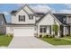 Charming two-story home with white siding, a two car garage, and well-maintained landscaping at 2705 Penn Ave, Plainfield, IN 46168