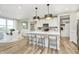 Bright, open kitchen with a large island, modern pendant lighting, and stainless steel appliances at 2705 Penn Ave, Plainfield, IN 46168
