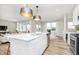 Open-concept kitchen with an island, stainless steel appliances, and seamless transition to living and dining areas at 2705 Penn Ave, Plainfield, IN 46168