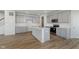 Well-designed kitchen with gray cabinets, quartz counters, island, and stainless appliances at 2705 Penn Ave, Plainfield, IN 46168