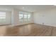 Bright living room features hardwood floors, recessed lighting, and large windows offering natural light at 2705 Penn Ave, Plainfield, IN 46168