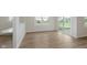 Open living area offers hardwood flooring, neutral walls, and natural lighting at 2705 Penn Ave, Plainfield, IN 46168