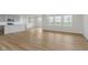 Open living room features light wood floors, neutral walls, and seamlessly flows into the kitchen at 2705 Penn Ave, Plainfield, IN 46168