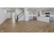 Open living area with wood floors, large windows, and stairs leading to the upper level at 2705 Penn Ave, Plainfield, IN 46168