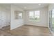 Open-concept living space with hardwood flooring and ample light from large windows at 2705 Penn Ave, Plainfield, IN 46168