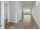Open-concept living room featuring light wood floors, staircase with dark railing, and recessed lighting at 2705 Penn Ave, Plainfield, IN 46168