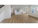 Spacious living room features stylish wood floors and flows to a modern kitchen area at 2705 Penn Ave, Plainfield, IN 46168