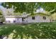 Expansive backyard featuring a patio area, fire pit, and lush green lawn, perfect for outdoor entertaining and relaxation at 305 N 1100 E, Zionsville, IN 46077