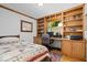 Bedroom featuring hardwood floors, custom built in storage, desk area and a window with views of the exterior at 305 N 1100 E, Zionsville, IN 46077