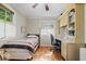Bright bedroom with hardwood floors, ceiling fan, and a window with views of the exterior at 305 N 1100 E, Zionsville, IN 46077