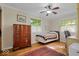 Bright bedroom with hardwood floors, ceiling fan, and a window with views of the exterior at 305 N 1100 E, Zionsville, IN 46077