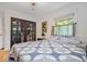 Bright bedroom with hardwood floors, ceiling fan, and two windows with views of the exterior at 305 N 1100 E, Zionsville, IN 46077