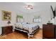 Bright bedroom with hardwood floors, ceiling fan, and two windows with views of the exterior at 305 N 1100 E, Zionsville, IN 46077