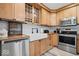 Charming kitchen with wooden cabinets, farmhouse sink, stainless steel appliances and white subway tile backsplash at 305 N 1100 E, Zionsville, IN 46077