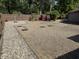 Large backyard featuring gravel landscaping, a small shed, a garden, and a wooden fence at 309 Arlington Dr, Whiteland, IN 46184