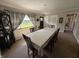 Traditional dining room featuring a long table for 6, neutral decor and a view to the front yard at 309 Arlington Dr, Whiteland, IN 46184