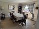 Traditional dining room featuring a long table for 6, neutral decor and a view to the front yard at 309 Arlington Dr, Whiteland, IN 46184