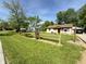 Charming single-Gathering home with a well-maintained lawn, a split rail fence, and mature shade trees at 309 Arlington Dr, Whiteland, IN 46184