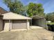 Detached garage with an attached carport for extra covered parking or storage at 309 Arlington Dr, Whiteland, IN 46184