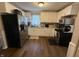 Eat-in kitchen featuring newer white cabinets and stainless steel appliances, and hardwood floors at 309 Arlington Dr, Whiteland, IN 46184