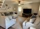 Cozy living room with neutral decor, comfortable seating, ceiling fan and a door to the outside at 309 Arlington Dr, Whiteland, IN 46184