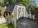This charming shed features board and batten siding, as well as, double doors and a lofted gambrel roof at 309 Arlington Dr, Whiteland, IN 46184