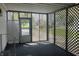 A covered porch with lattice design on the walls, and a door for entry into the house at 3161 Compass Dr, Franklin, IN 46131