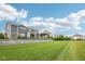 View of the backyard with lawn, retaining wall, pergola and landscaping at 3316 Shelborne Woods Pkwy, Carmel, IN 46032