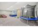 Spacious basement area with light carpet, a trampoline, climbing wall, and other activity-based structures at 3316 Shelborne Woods Pkwy, Carmel, IN 46032