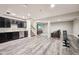 Spacious finished basement features wet bar, workout area, and comfortable seating with TV at 3316 Shelborne Woods Pkwy, Carmel, IN 46032