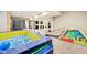 Finished basement with brightly-colored play area featuring a ball pit, slide, and mini trampoline at 3316 Shelborne Woods Pkwy, Carmel, IN 46032