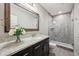 Bathroom featuring granite vanity top, dark cabinets and glass enclosed shower at 3316 Shelborne Woods Pkwy, Carmel, IN 46032