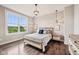 Stylish bedroom features a large window, hardwood floors, and rustic modern decor at 3316 Shelborne Woods Pkwy, Carmel, IN 46032