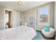 This bedroom features a cozy beanbag chair, white furniture, and bright natural light at 3316 Shelborne Woods Pkwy, Carmel, IN 46032