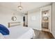 Bright bedroom features hardwood floors, ensuite bathroom, and modern rustic decor at 3316 Shelborne Woods Pkwy, Carmel, IN 46032