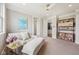 Inviting bedroom with a comfortable seating area, built-in shelving, and multiple access points at 3316 Shelborne Woods Pkwy, Carmel, IN 46032