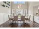 Elegant dining area with hardwood floors, stylish lighting fixture, and scenic views from the bright windows at 3316 Shelborne Woods Pkwy, Carmel, IN 46032