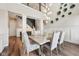 Elegant dining area with hardwood floors, stylish lighting, and easy access to the staircase at 3316 Shelborne Woods Pkwy, Carmel, IN 46032