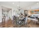 Spacious dining area with hardwood floors, views to the living room, entrance and bar area. Round table seats six at 3316 Shelborne Woods Pkwy, Carmel, IN 46032