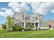 Charming exterior showcasing a well-kept lawn and professional landscaping at 3316 Shelborne Woods Pkwy, Carmel, IN 46032